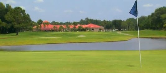 Green, lake and Clubhouse in background.